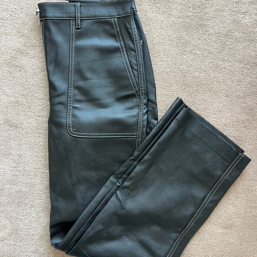 Aritzia Wilfred faux leather black pants with contrast white stitching.